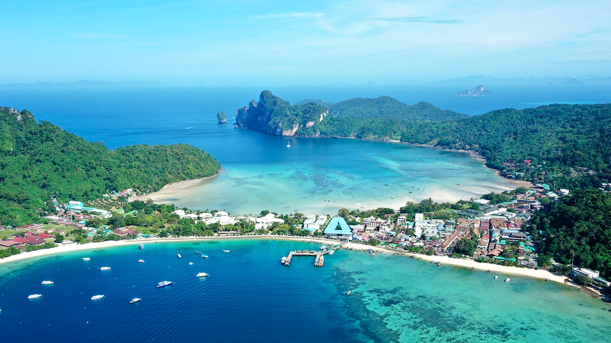 Aerial view of Tonsai Village, Phi Phi Islands, with boats in turquoise waters.