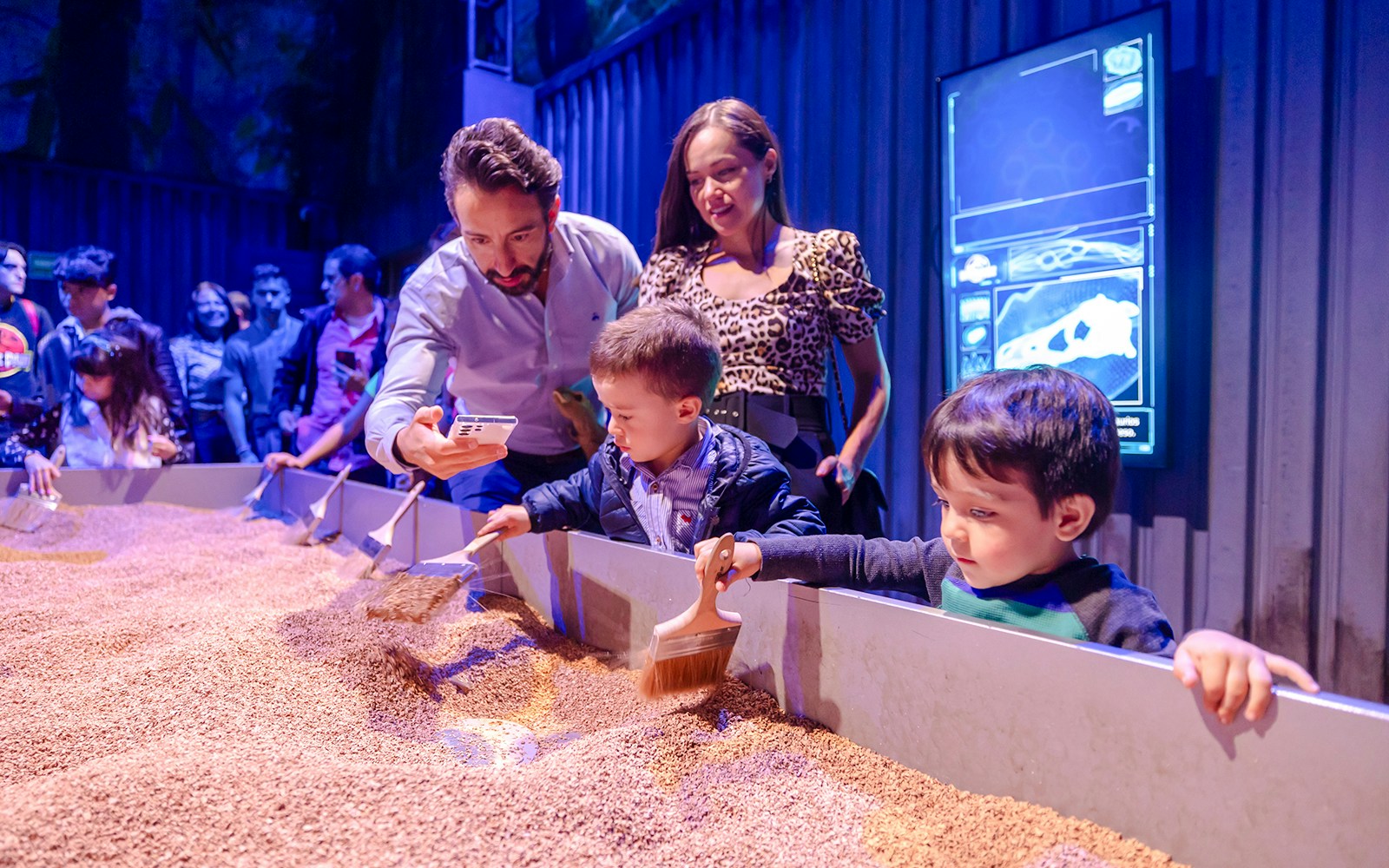 tourists interacting with dig site exhibit