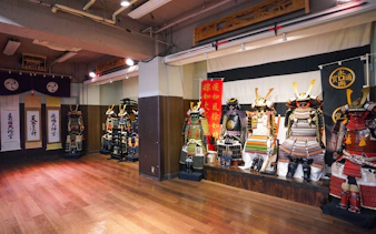 Samurai armor display in Tokyo dojo for swordplay and dining experience.