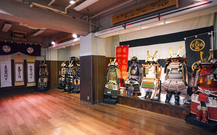 Samurai armor display in Tokyo dojo for swordplay and dining experience.