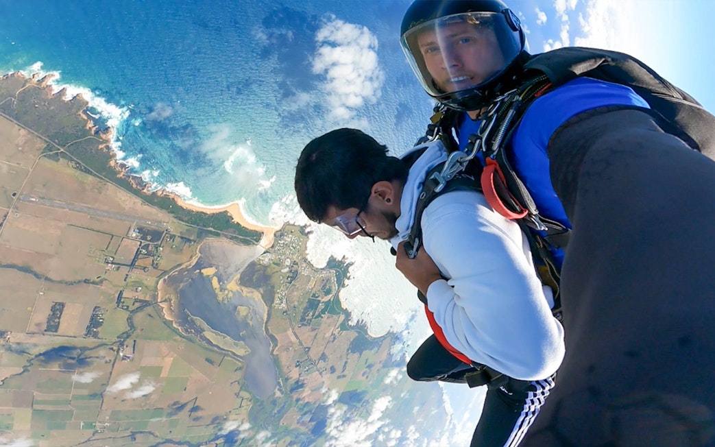 Tandem skydive over Great Ocean Road coastline near 12 Apostles, Australia.