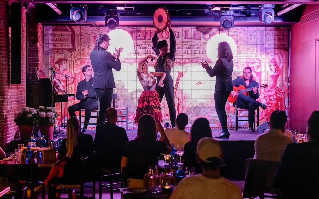 Flamenco performance at Flamenco De Leones with dancers and musicians on stage.