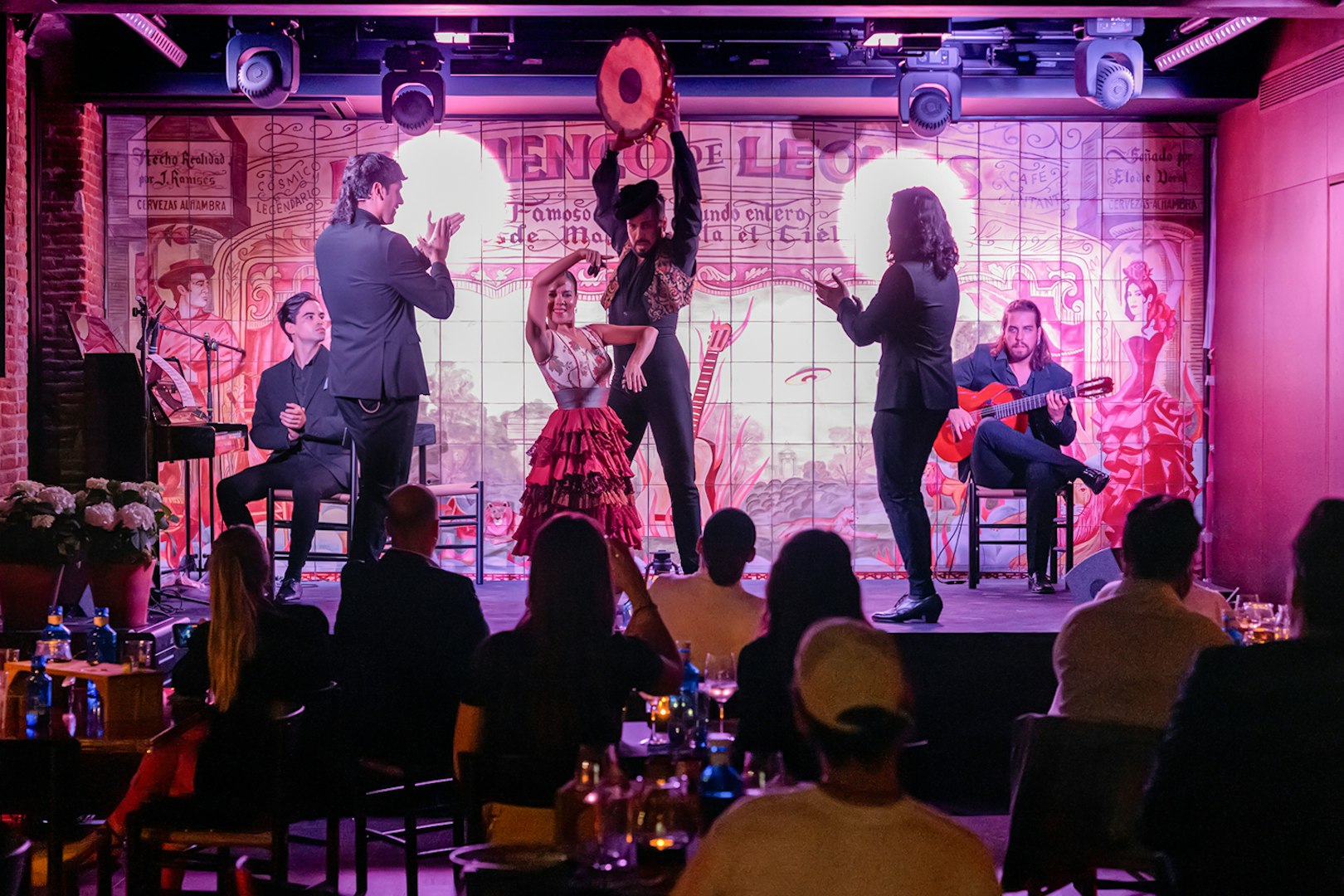 Flamenco performance at Flamenco De Leones with dancers and musicians on stage.