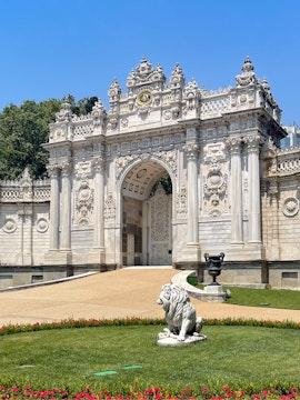 Dolmabahçe Palace gate with ornate architecture and lion statue, Istanbul.