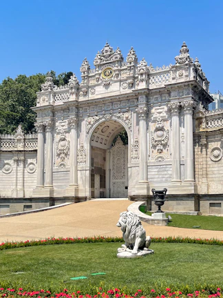 Dolmabahçe Palace gate with ornate architecture and lion statue, Istanbul.