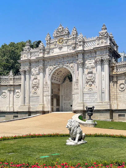 Dolmabahçe Palace gate with ornate architecture and lion statue, Istanbul.