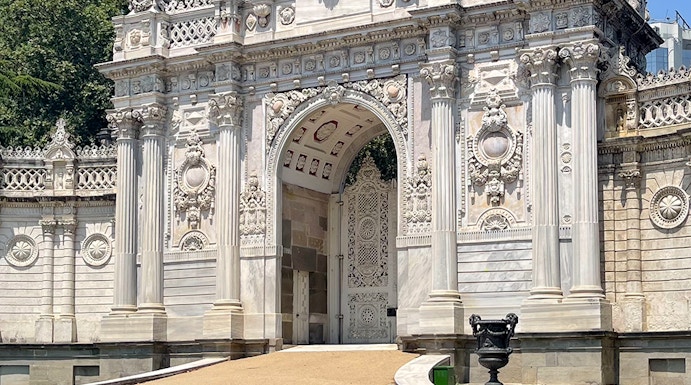 Dolmabahçe Palace gate with ornate architecture and lion statue, Istanbul.