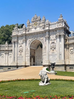 Dolmabahçe Palace gate with ornate architecture and lion statue, Istanbul.