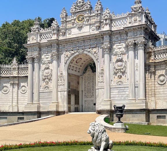 Dolmabahçe Palace gate with ornate architecture and lion statue, Istanbul.