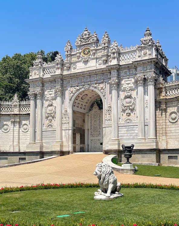 Dolmabahçe Palace gate with ornate architecture and lion statue, Istanbul.