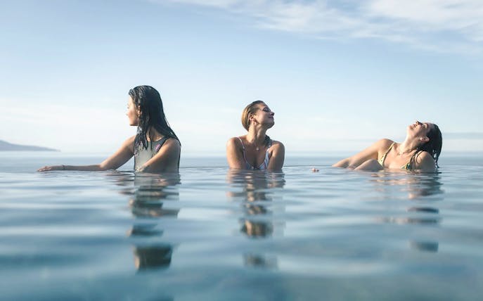 Guests enjoying Geosea Geothermal Baths with ocean view in Iceland.