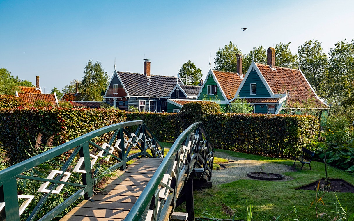 Bridge leading to traditional Dutch houses in Zaanse Schans, Netherlands.