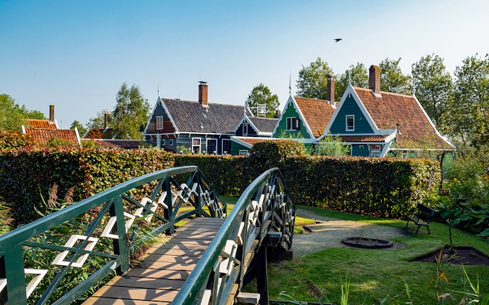 Bridge leading to traditional Dutch houses in Zaanse Schans, Netherlands.