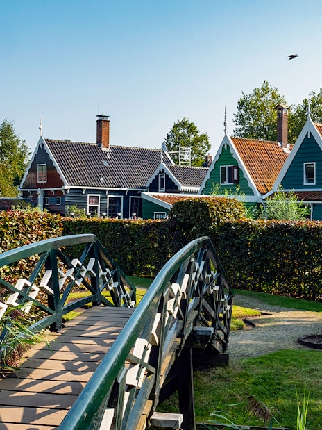 Bridge leading to traditional Dutch houses in Zaanse Schans, Netherlands.