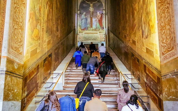 Pilgrims ascending the Holy Stairs at the Basilica of Saint John in Lateran, Rome.