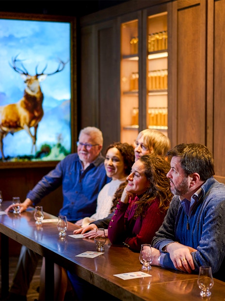 Visitors listening to a guide during the Scotch Whisky Experience Silver Tour.