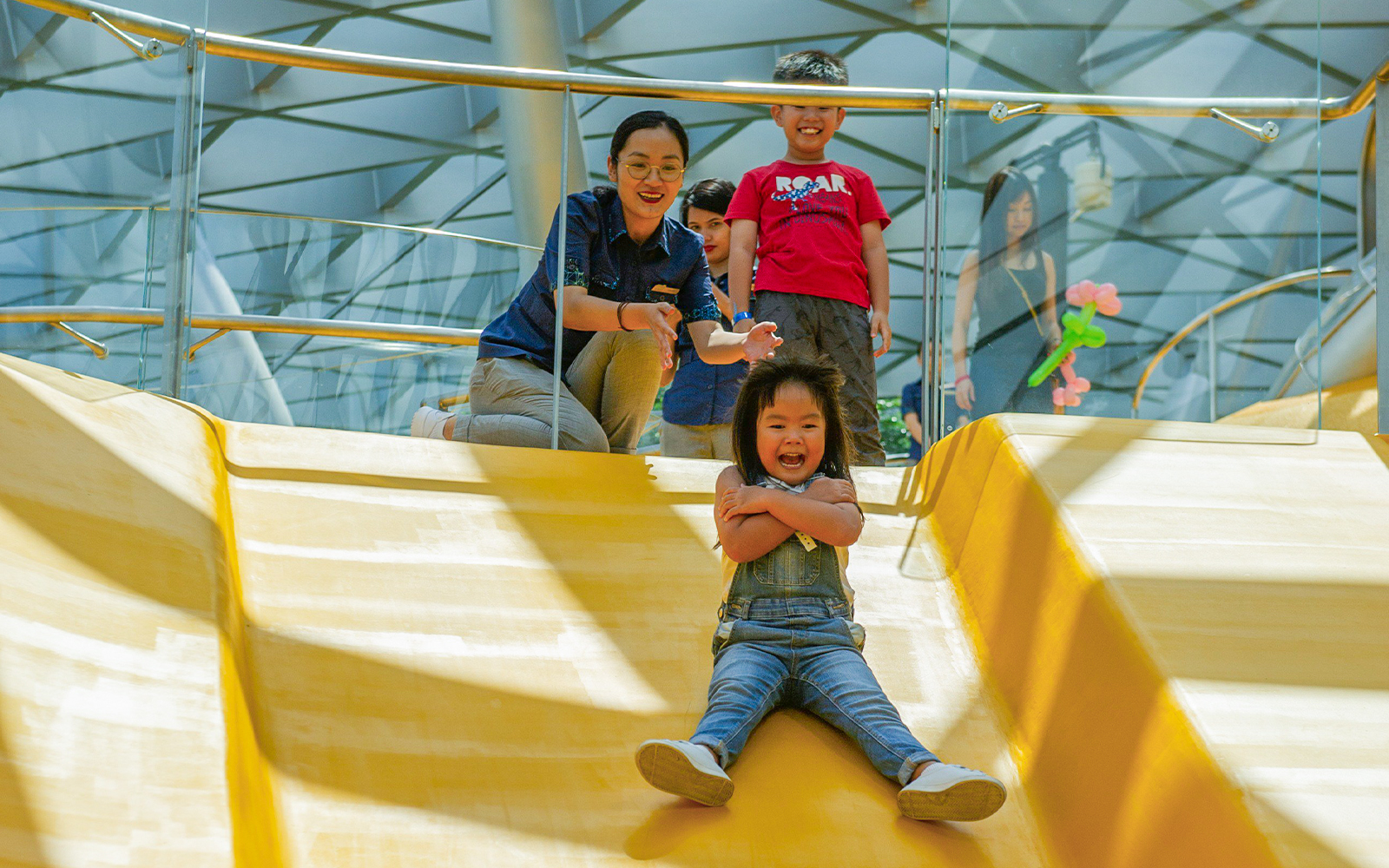 Child sliding down Discovery Slides at Jewel Changi Airport, Singapore.