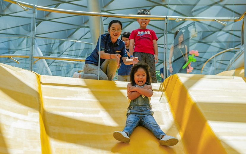 Child sliding down Discovery Slides at Jewel Changi Airport, Singapore.