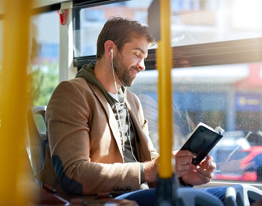 Solo traveler on a bus admiring the scenic view in Valencia through the window.