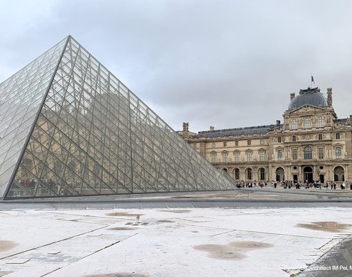 Louvre Museum glass pyramid entrance in Paris, France.