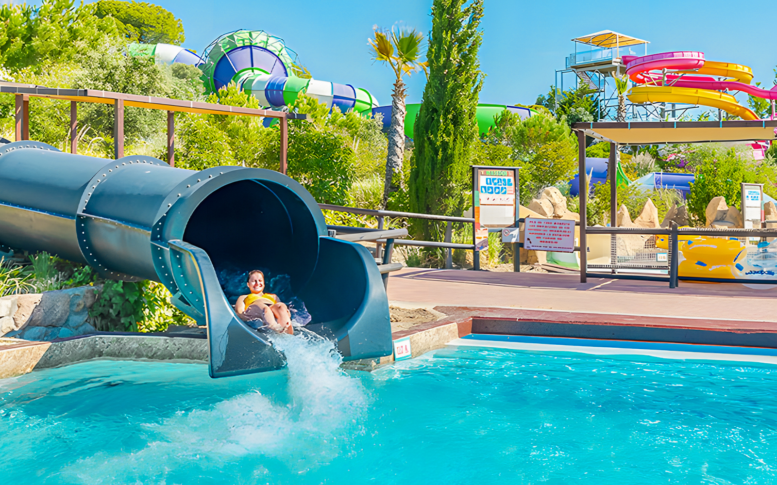 Child sliding down Black Hole water slide at Aquopolis Villanueva de la Cañada.