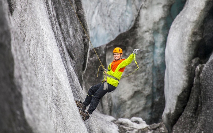 Guest ice climbing on a glacier in Skaftafell, Iceland.