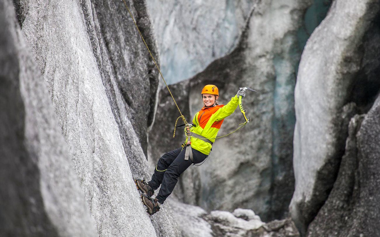 Guest ice climbing on a glacier in Skaftafell, Iceland.