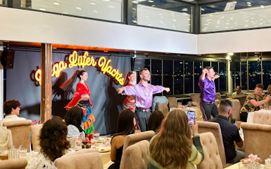 Dancers performing traditional Turkish show on Bosphorus dinner cruise with private tables.