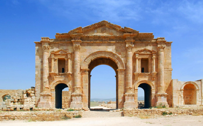 Arch of Hadrian at Jerash Ruins, Jordan, showcasing ancient Roman architecture.