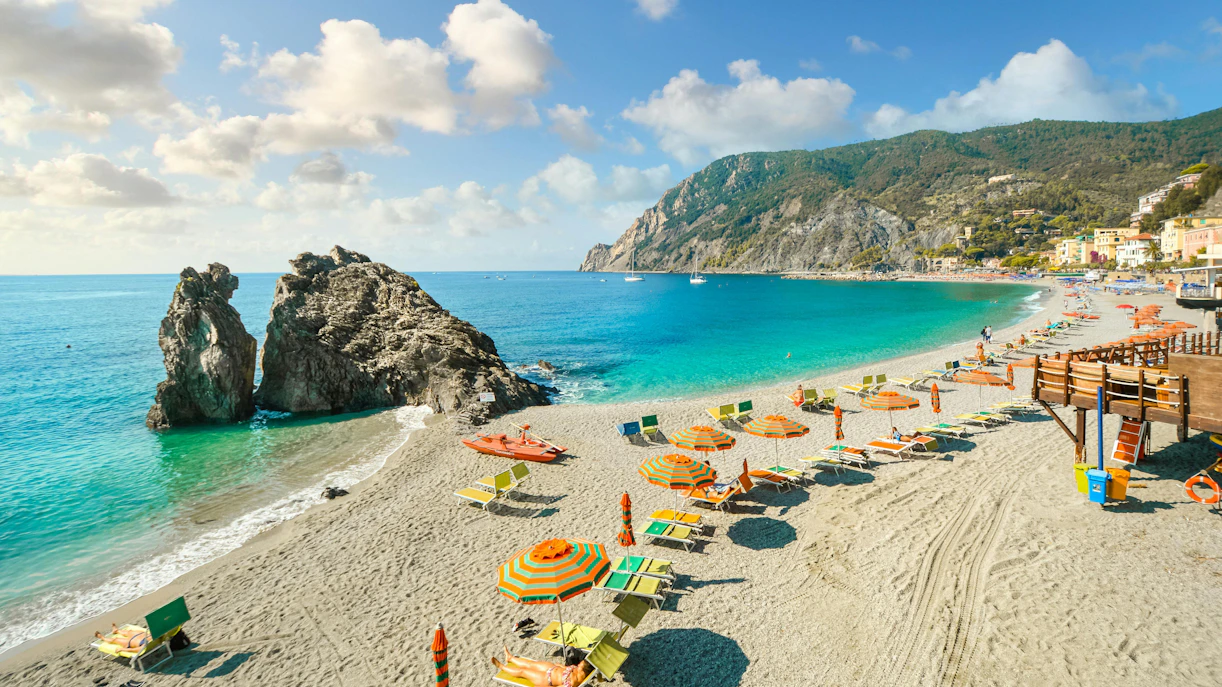 Chairs and umbrellas on Spiaggia di Fegina beach, Monterosso al Mare, Cinque Terre, Italy.