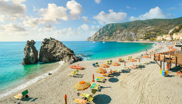 Chairs and umbrellas on Spiaggia di Fegina beach, Monterosso al Mare, Cinque Terre, Italy.