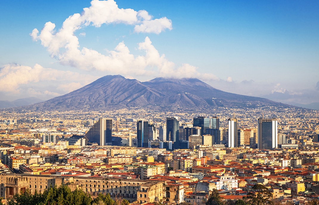 Naples city skyline with Mount Vesuvius in the background.