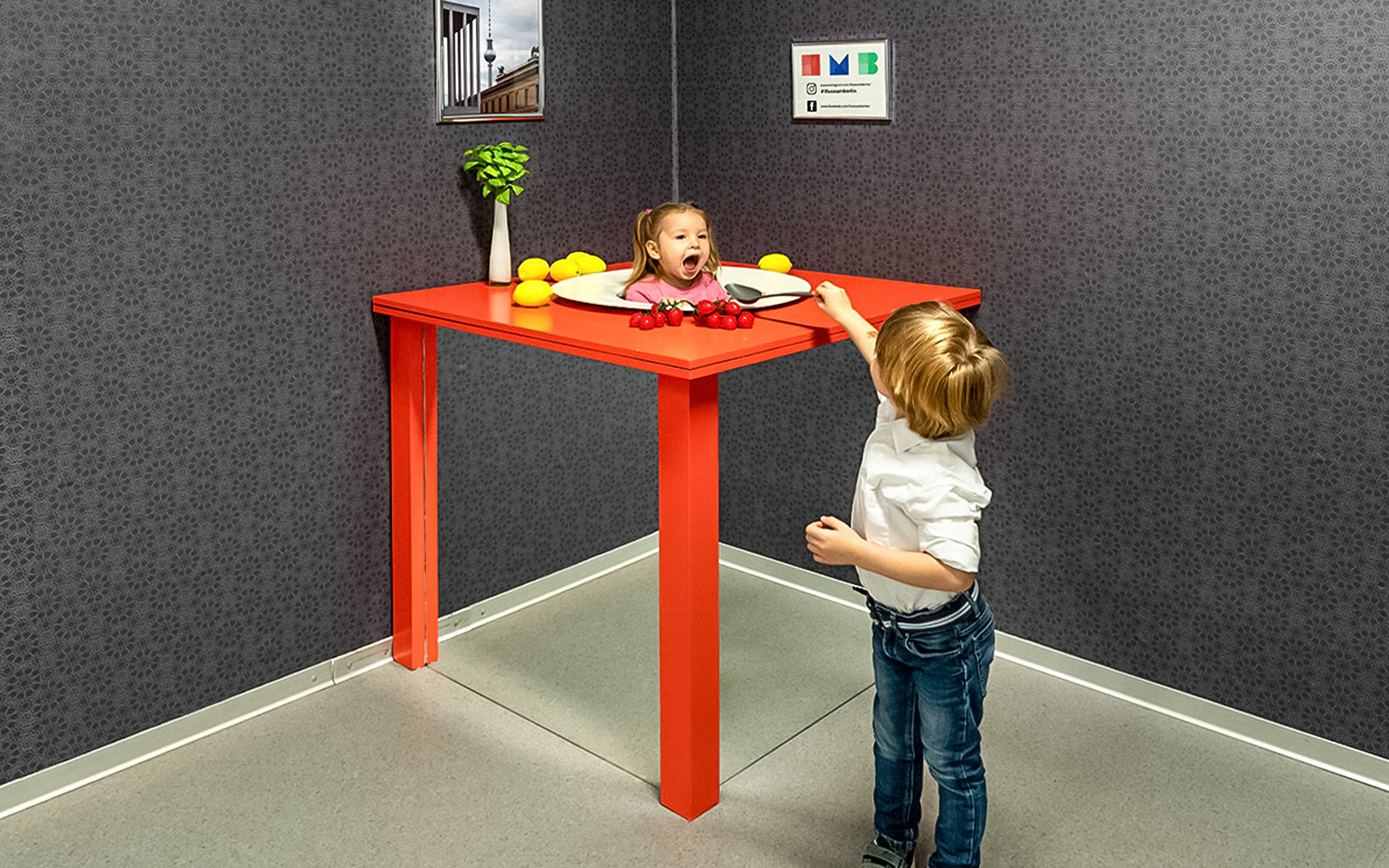 Child interacting with optical illusion exhibit at Illuseum Berlin.
