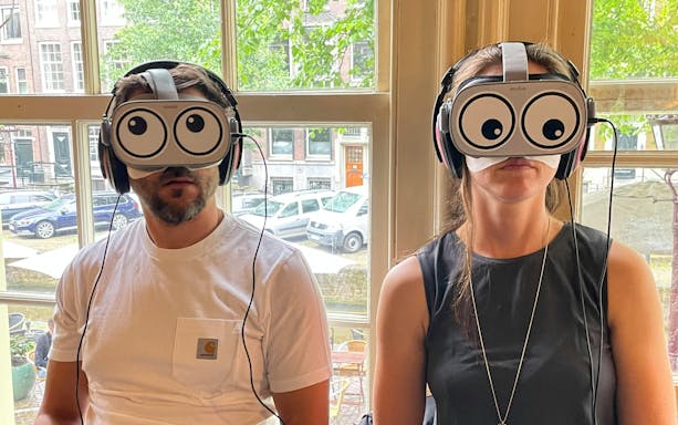 Visitors using VR headsets during Anne Frank House tour in Amsterdam.