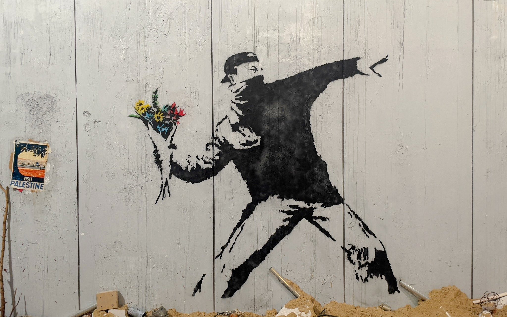 Protester mural holding flowers at Banksy Museum, Amsterdam.