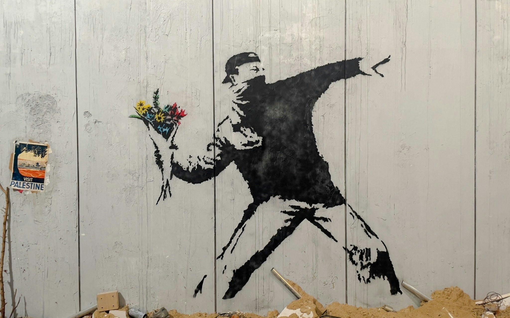 Protester mural holding flowers at Banksy Museum, Amsterdam.