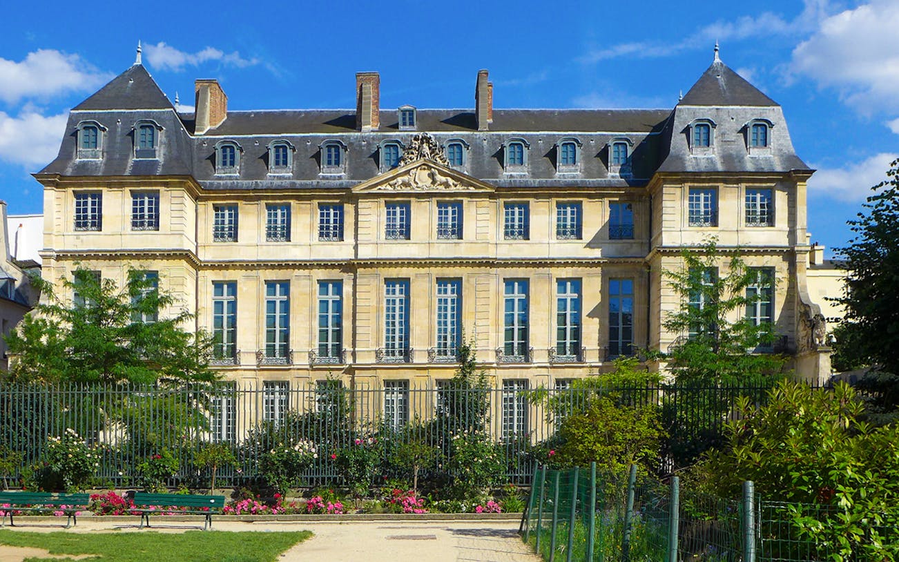 Picasso Museum exterior in Paris with garden and blue sky.