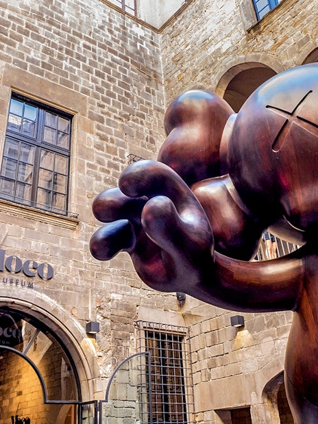 Moco Museum entrance in Barcelona with large sculpture, featuring Banksy artworks.