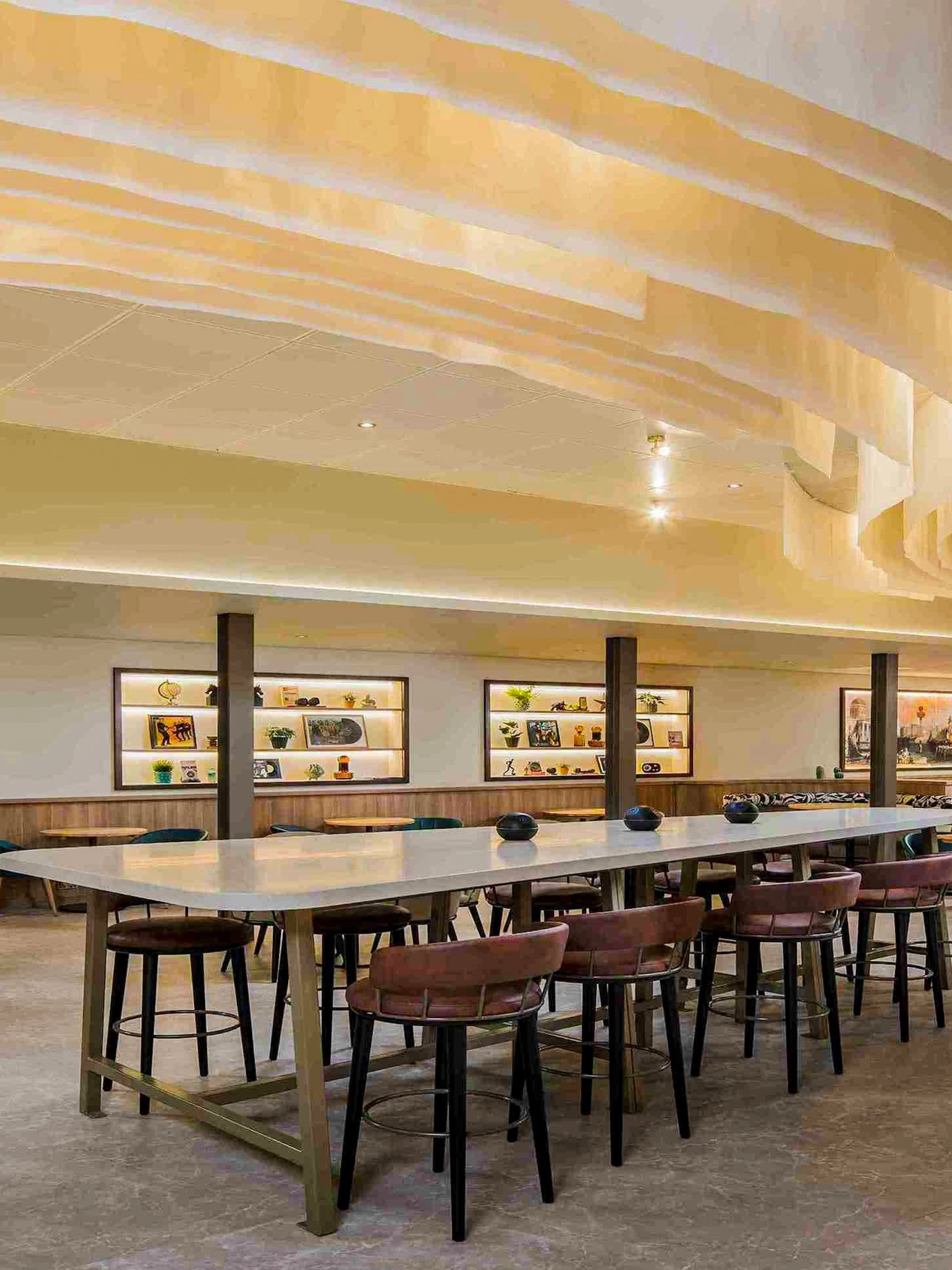 Aspire Lounge seating area with modern decor at John Lennon Airport.