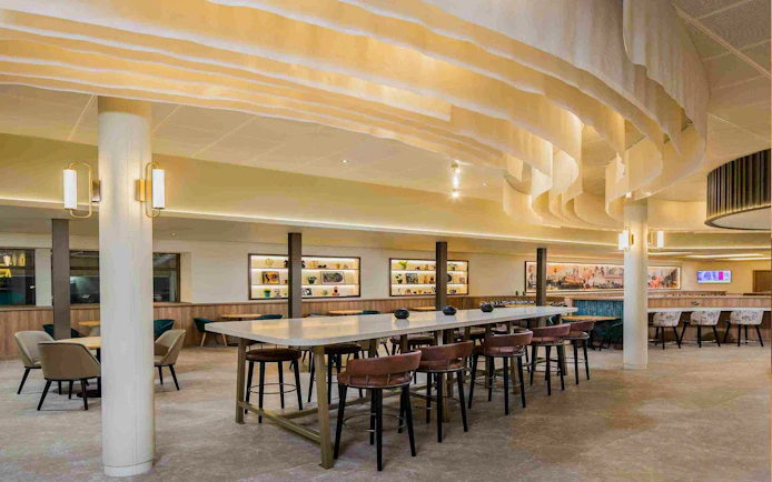Aspire Lounge seating area with modern decor at John Lennon Airport.