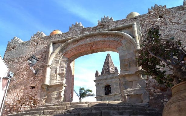 Ancient stone archway in Savoca, Sicily, featured in The Godfather Tour from Catania.