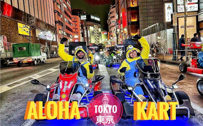 Tourists in costumes driving go-karts on a busy Shibuya street in Tokyo.