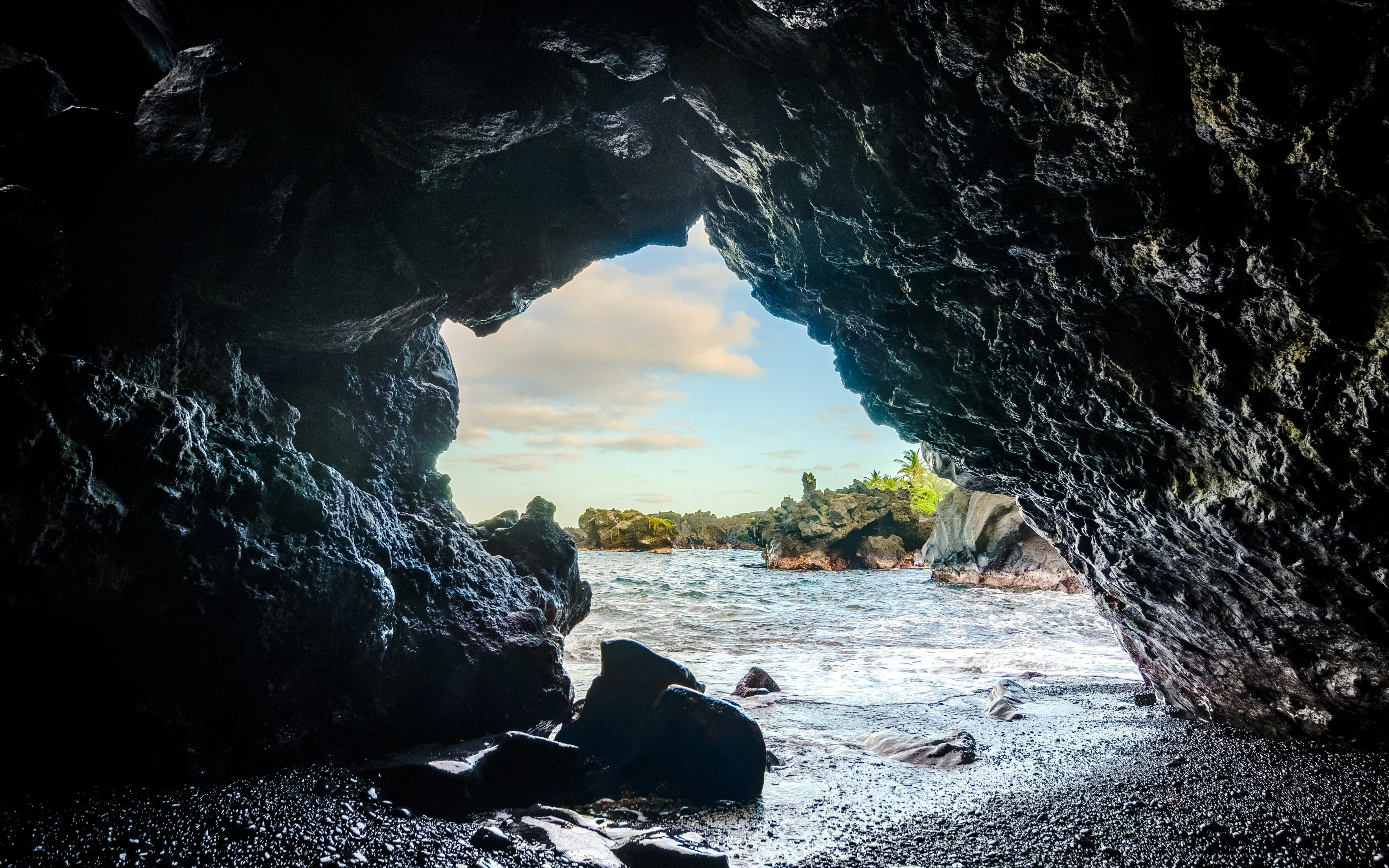 Cave opening view of ocean and rocky shore at Waiʻanapanapa State Park, Hawaii.