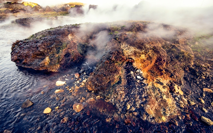 Steaming geothermal rocks at Secret Lagoon, Gamla Laugin, Iceland.