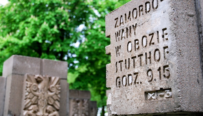 Stutthof concentration camp entrance with historical buildings, part of Warsaw tour.