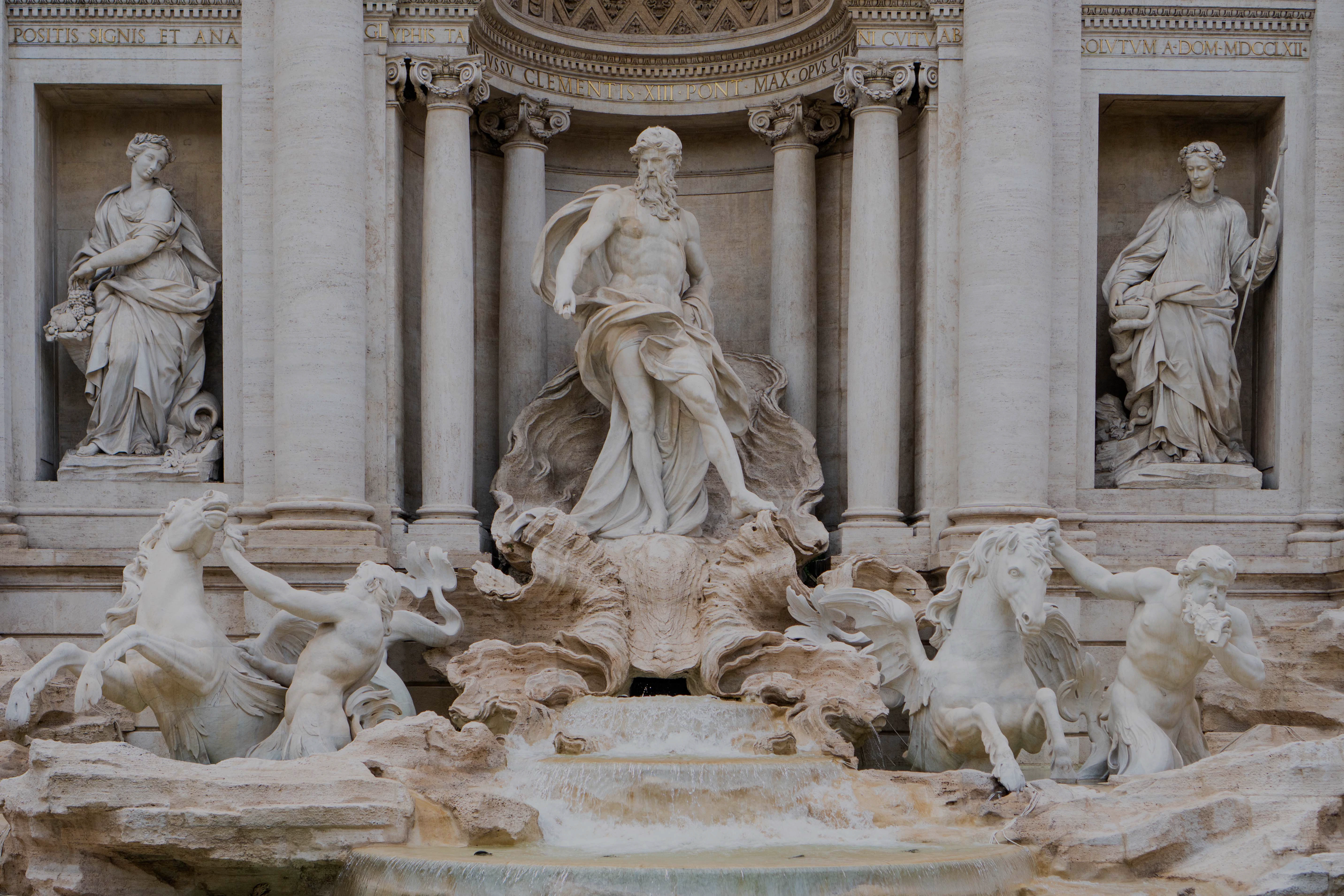 Trevi Fountain closeup featuring Oceanus statue and horses in Rome, Italy.