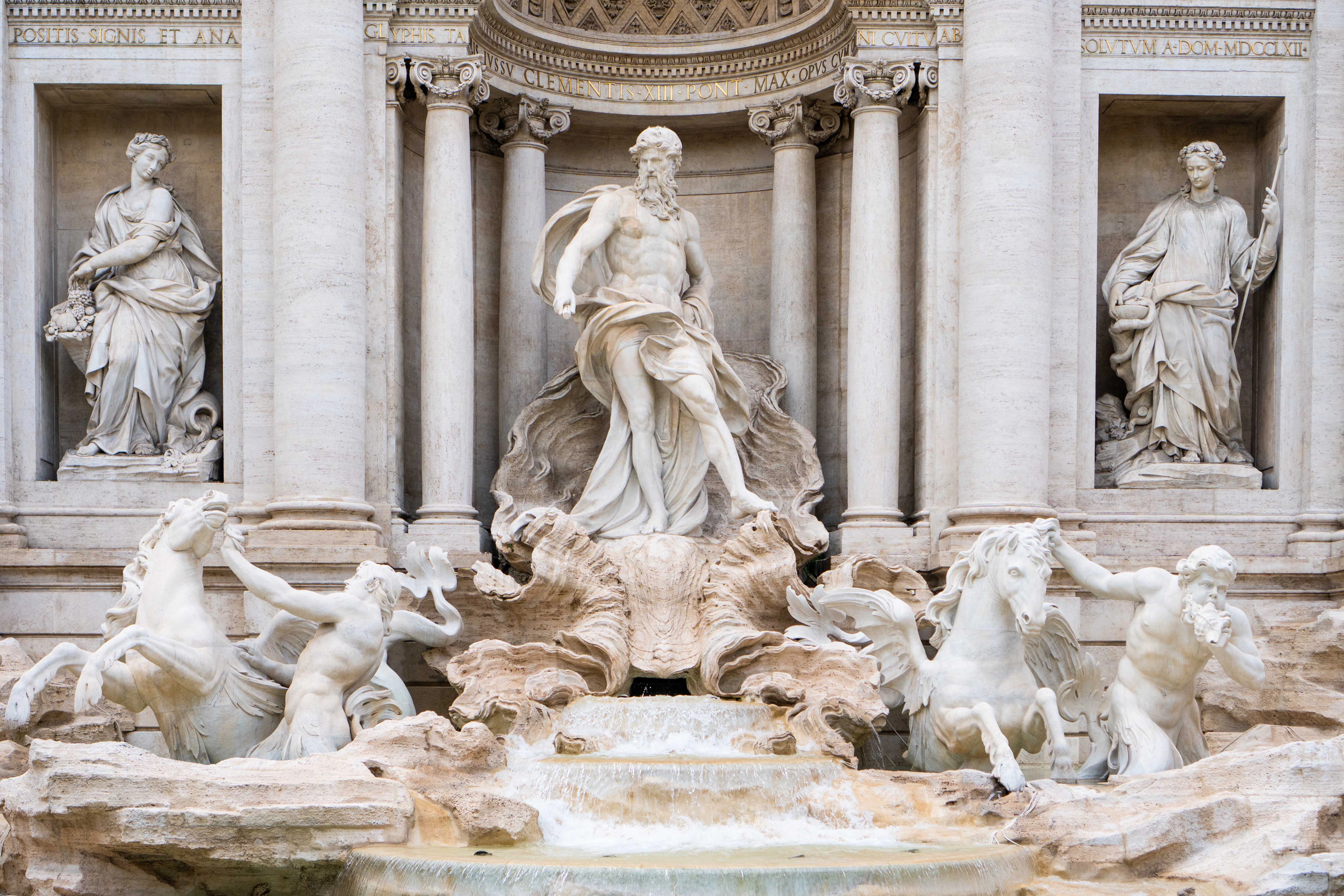 Trevi Fountain closeup featuring Oceanus statue and horses in Rome, Italy.