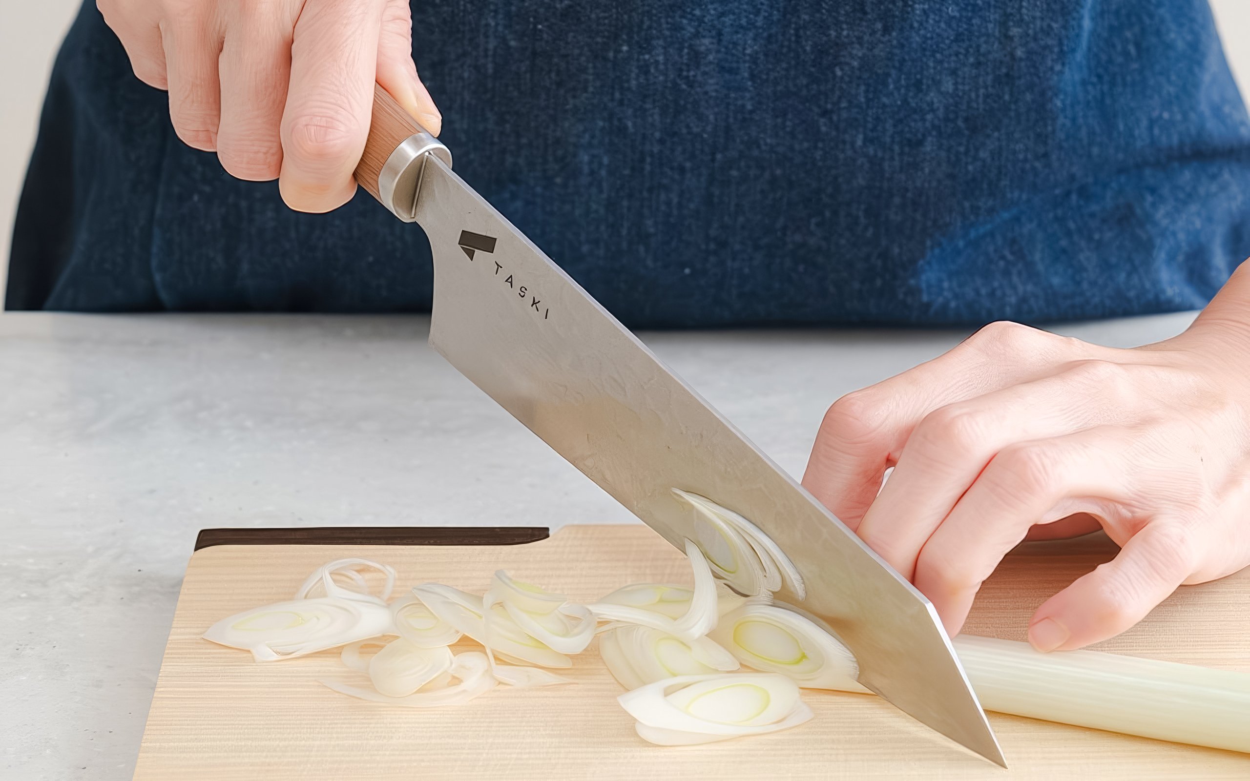 Chef slicing onion at Tokyo cooking class for ramen and gyoza.