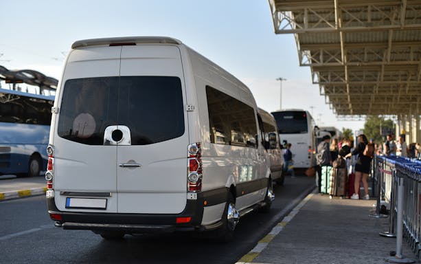 Private airport transfer van at Kota Kinabalu International Airport terminal.