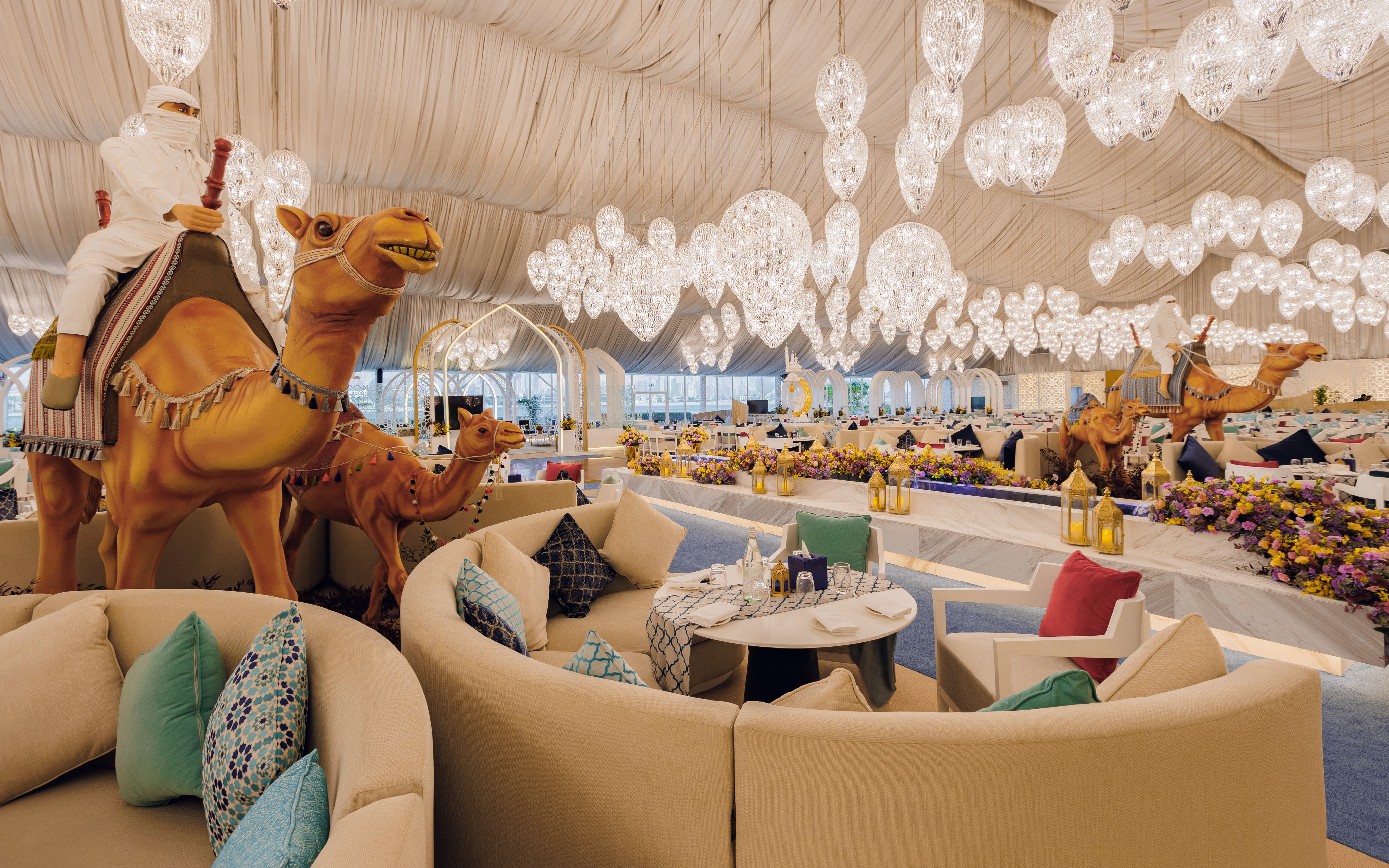 Interior of Asateer Tent at Atlantis, The Palm, Dubai, decorated for Ramadan with seating and chandeliers.